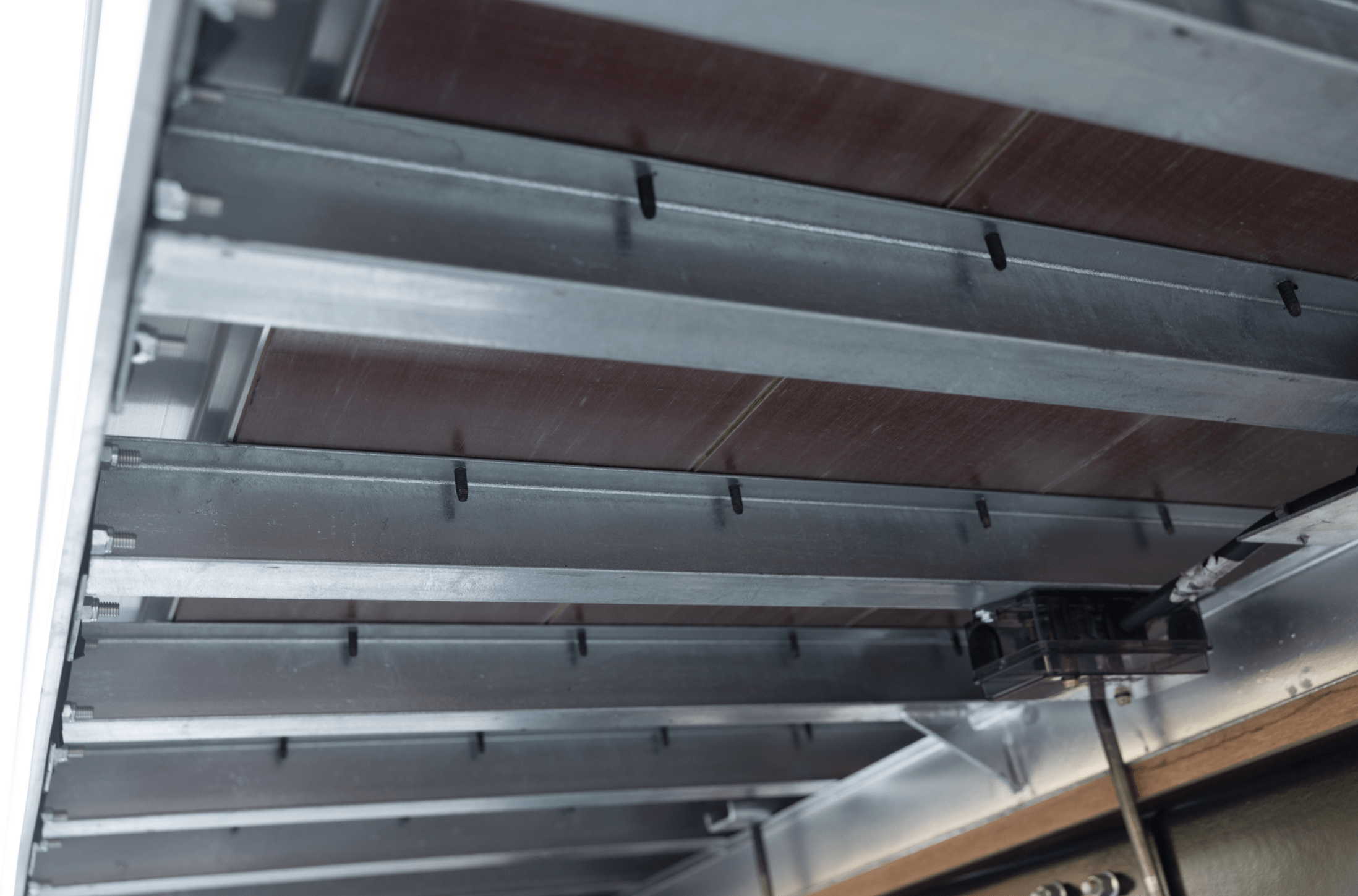 Close-up view of the underside structure of a Hyundai Translead Anza truck body or trailer, showcasing its robust construction and advanced engineering, indicative of Hyundai's innovation and trailer technology.